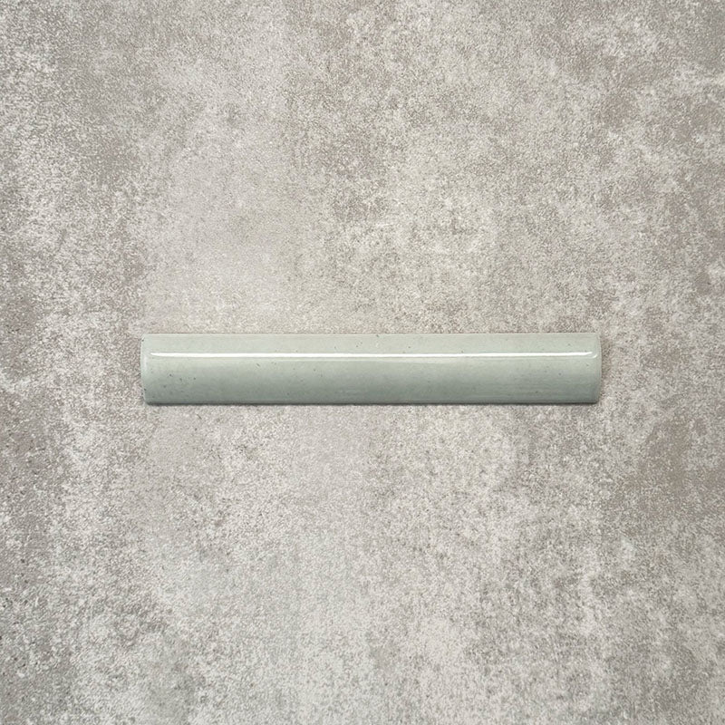 Nomad Mint Green bullnose pencil border ceramic tile in a 3 × 20cm format, shown as a single piece highlighting the soft green colour, gloss finish and rounded profile.