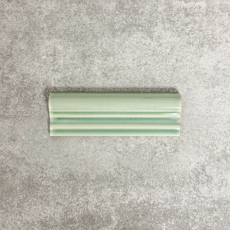 Pimlico Lime Green dado trim tile measuring 5 × 15cm, finished with a crackle glaze and soft green tone, designed to add a decorative feature line and classic detail to ceramic wall tile installations.