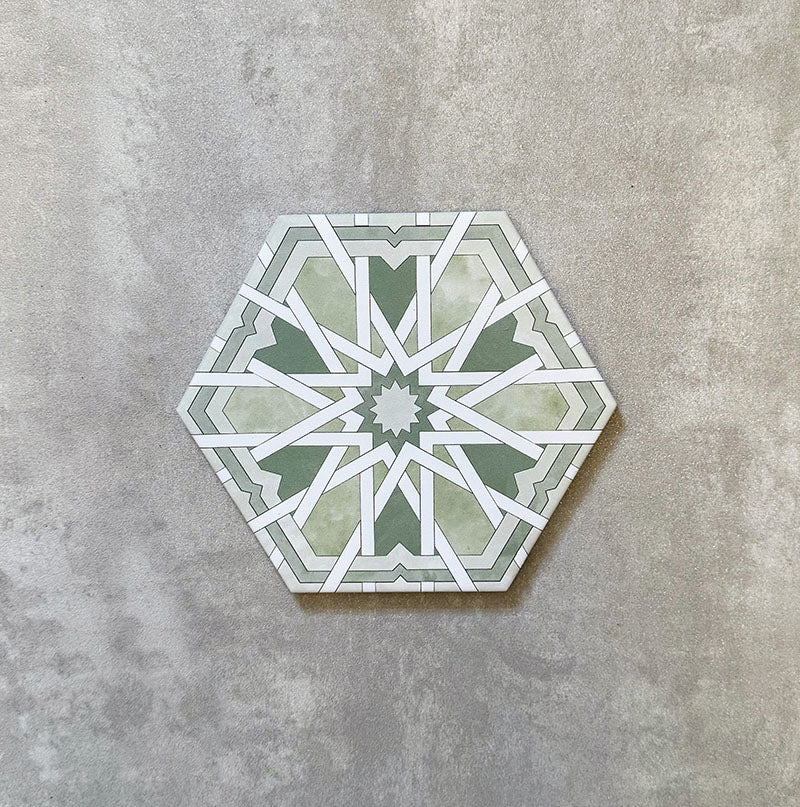 Single Medina Hormuz Verde Green Moroccan-style hexagon porcelain tile, 18.7 × 21.6 cm, featuring a bold star-inspired geometric pattern in green and white tones on a neutral background.
