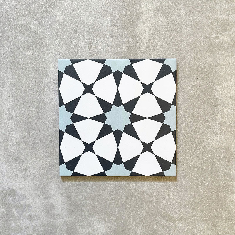 Agadir Azul Blue Moroccan-style 20x20cm porcelain tile featuring a geometric star pattern in blue, black and white, shown as a single tile on a neutral background.
