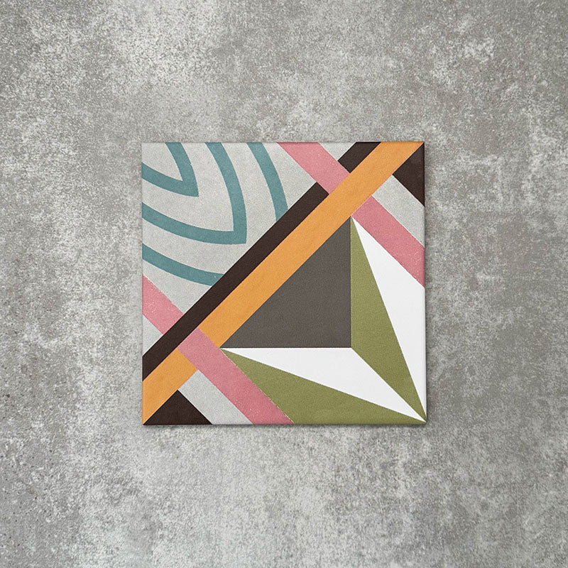 Single Cuba Star Moroccan-style porcelain tile in a 20×20cm square format, featuring a bold geometric design with intersecting lines in soft green, blue, pink, grey and mustard tones, shown against a neutral background to highlight the tile’s crisp pattern and matt finish.