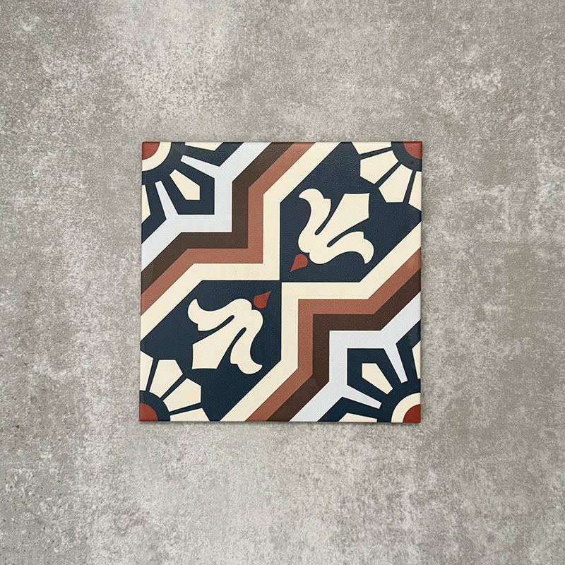 Single Balthazar Grand 20×20cm Moroccan-style porcelain tile displayed against a neutral stone-effect background, highlighting the detailed geometric pattern in deep blue, warm brown and soft cream tones with a traditional encaustic-inspired design and crisp matt finish.