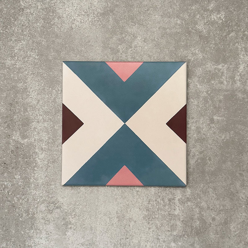 Single Cuba Guazzatto Moroccan-style porcelain tile in a 20×20cm square format, featuring a bold geometric cross motif in soft blue, white, pink and burgundy tones, shown against a neutral background to highlight the tile’s clean lines and contemporary encaustic-style design.