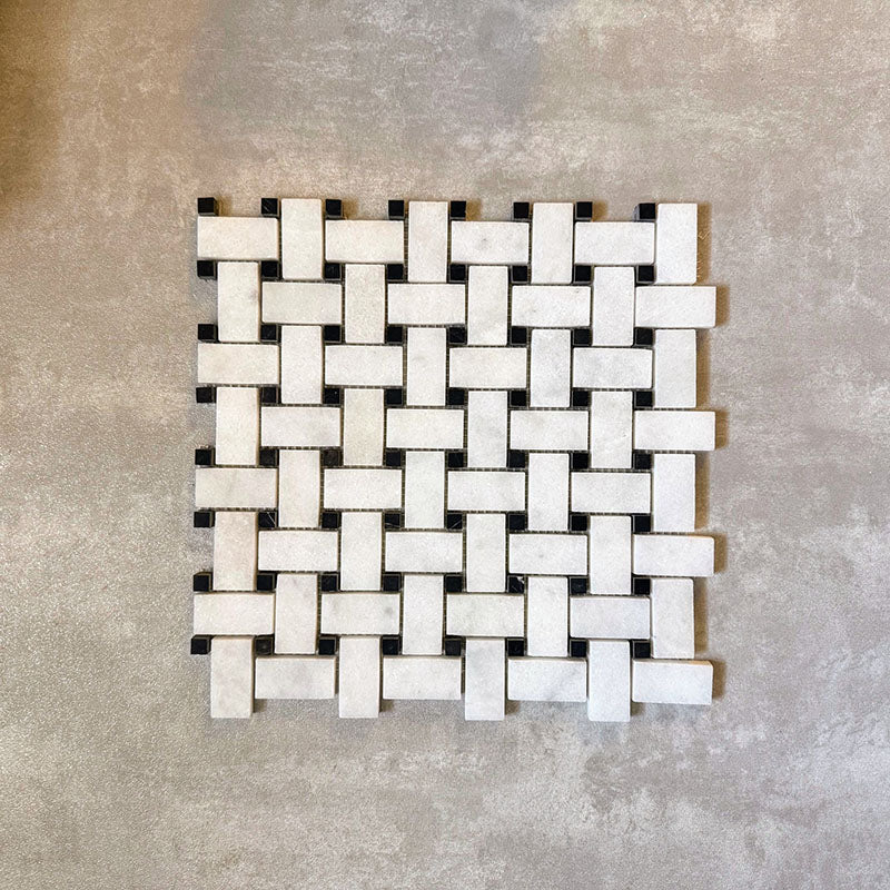 Single Fayrouz Black & White basketweave mosaic natural marble tile with a honed finish, featuring an intricate woven pattern with contrasting dark accents, displayed against a neutral textured background in a clean product setting.