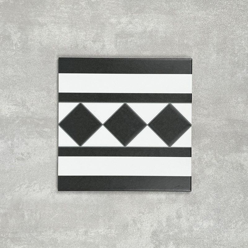 Single Dorset Black & White Victorian-style porcelain border tile in a 25 × 25cm format, featuring a classic striped and diamond geometric design, shown on a neutral background to highlight the contrasting black and white detailing used for decorative borders.