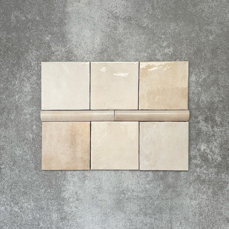 Zellige Bone bullnose ceramic tiles in a soft beige tone, paired with matching square tiles in a flat lay layout.