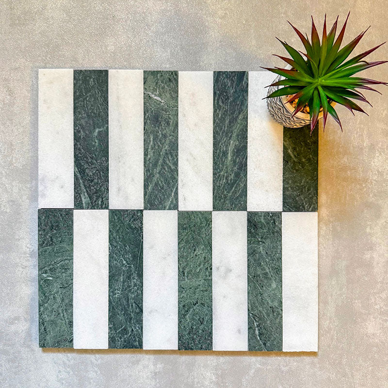 Arrangement featuring Fayrouz White 5x20cm natural marble tiles with a honed finish, paired with green marble pieces in a striped layout, highlighting soft white tones with subtle grey veining alongside rich green variation for contrast and visual interest.