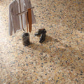 Overhead view of the Stuzzi Amber 60x120cm terrazzo style porcelain floor tiles, showcasing a warm amber base with multicoloured stone fragments in cream, ochre, rust, charcoal and grey. The realistic 4D brushed finish adds texture and depth, creating a striking terrazzo effect in a contemporary interior.