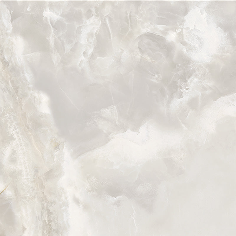 Close-up of Thebes White honed matt onyx effect porcelain tile in a 60cm x 60cm format, showcasing soft ivory and warm beige tones with delicate translucent veining and a realistic natural onyx effect finish.
