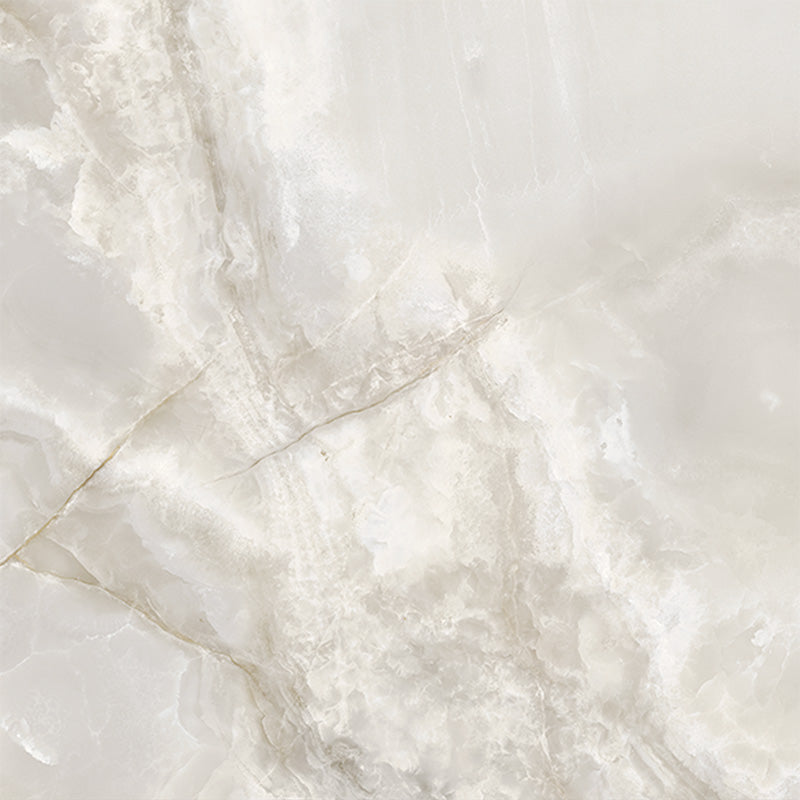 Close-up of Thebes White honed matt onyx effect porcelain tile in a 60cm x 60cm format, showcasing soft ivory and warm beige tones with delicate translucent veining and a realistic natural onyx effect finish.