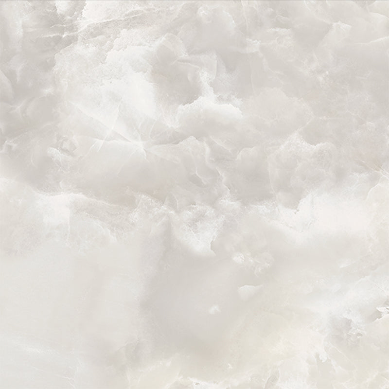 Close-up of Thebes White honed matt onyx effect porcelain tile in a 60cm x 60cm format, showcasing soft ivory and warm beige tones with delicate translucent veining and a realistic natural onyx effect finish.