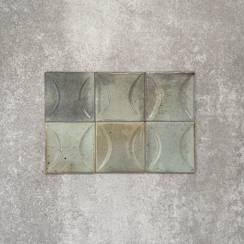 Close-up of Saigon Celadon Green Decor Square Wall tiles, featuring Moroccan-style 10 × 10cm glossy ceramic tiles in soft green and blue-grey tones with a curved decorative relief pattern.