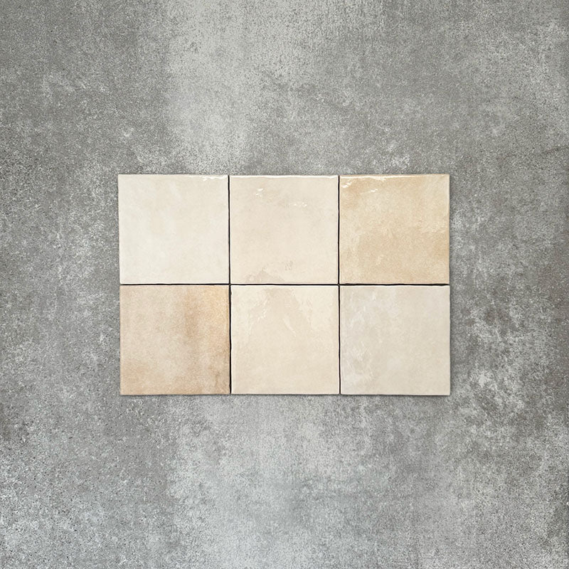 Zellige Bone square tiles laid in a simple grid, featuring a glossy white finish with subtle tonal variation and softly uneven edges.