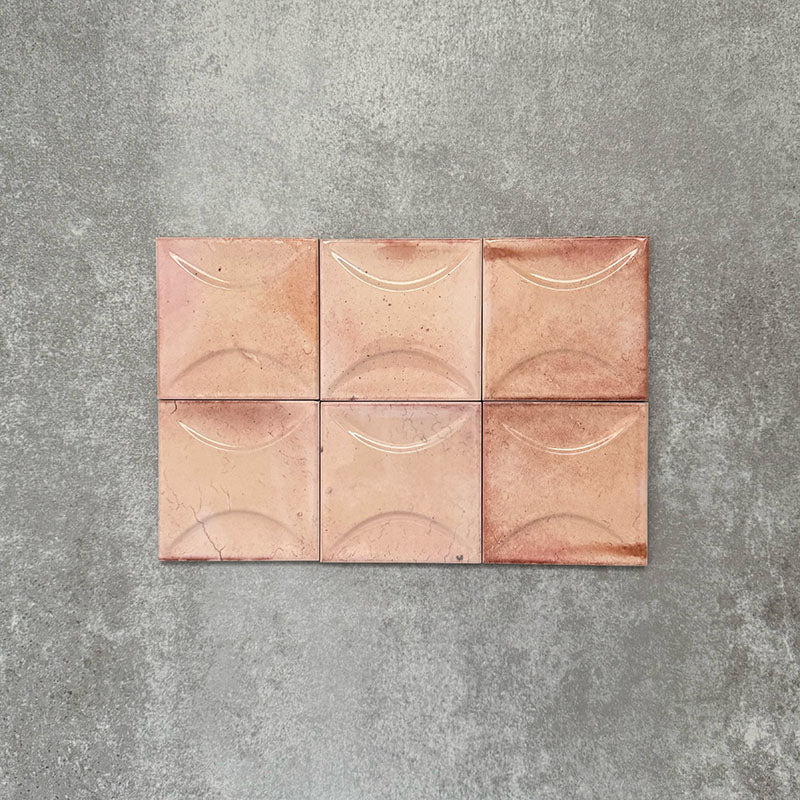Close-up of Saigon Rose Pink Decor Square Wall tiles, featuring Moroccan-style 10 × 10cm glossy ceramic tiles in soft blush and rose tones with a curved decorative relief pattern.