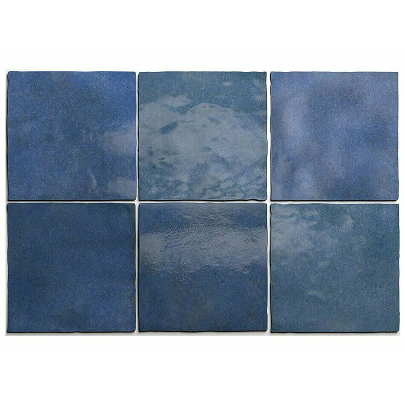 Flat lay of Zellige Royal Blue 13.2×13.2cm Moroccan-style ceramic square tiles, showcasing rich deep blue tones, subtle tonal variation and a glossy handmade-look glazed finish on a neutral background.