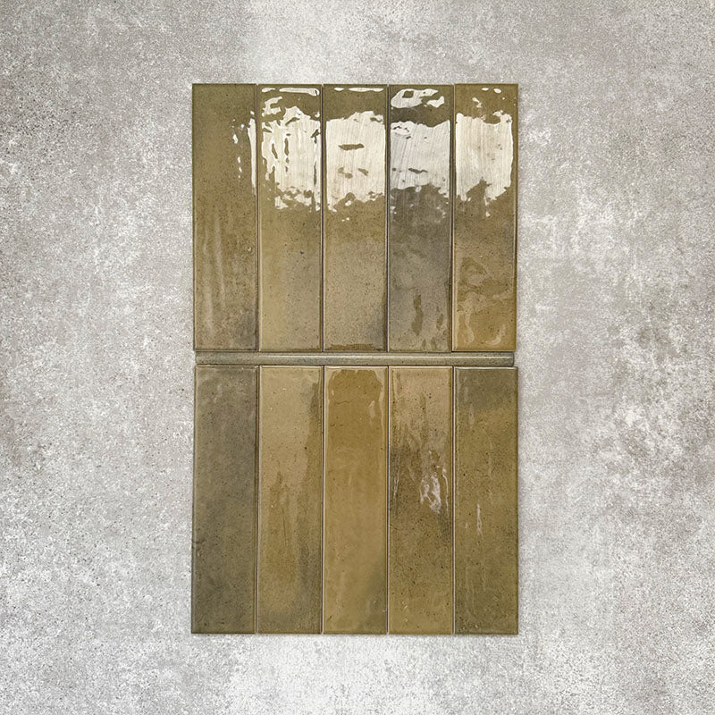 Allegra Daisy Green Gloss pencil bullnose border ceramic tiles in a 1.2 × 30cm format, shown laid vertically to highlight the rich green tones, glossy finish and subtle handmade-style variation, ideal for edging and decorative borders.