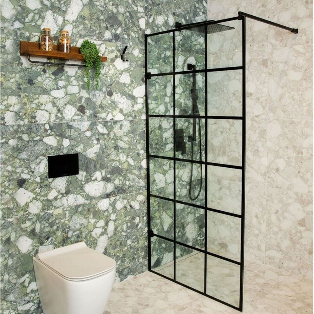 Contemporary bathroom featuring Venice Emerald matt terrazzo effect porcelain wall tiles paired with Venice Pearl terrazzo effect tiles, complemented by a black crittall shower screen, black brassware and warm wooden accents for a striking modern design.