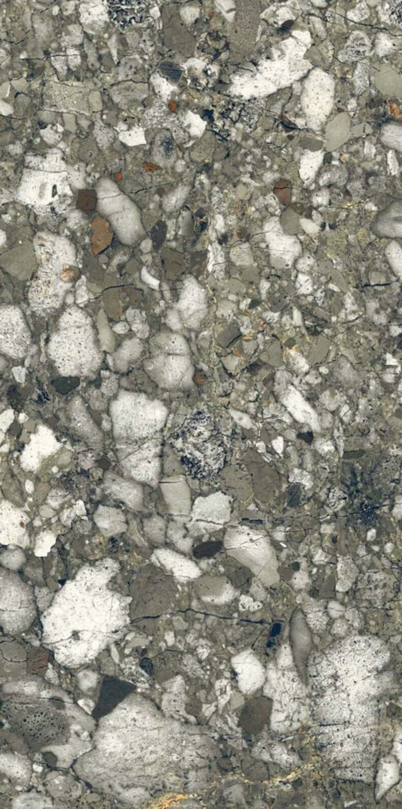 Close-up of Venice Emerald matt terrazzo effect porcelain tile, featuring a rich green-grey base with oversized marble chips and natural stone detailing, ideal for contemporary kitchen, bathroom and living room floors.