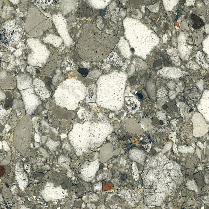 Close-up of Venice Emerald matt terrazzo effect porcelain tile, featuring a rich green-grey base with oversized marble chips and natural stone detailing, ideal for contemporary kitchen, bathroom and living room floors.