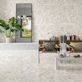Contemporary living space featuring Venice Ivory polished terrazzo effect porcelain wall and floor tiles, showcasing soft ivory tones with natural stone chips, paired with modern furniture and greenery for a bright, elegant interior.