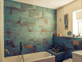Contemporary bathroom featuring Verde Copper Oxide 30cm x 60cm metallic effect wall and floor tiles, styled with a built-in bath, brass shower fittings and rich blue-green tones for a luxurious interior.