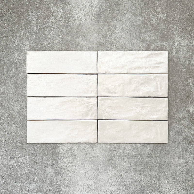 Vertical brick layout featuring Zellige Oyster Brick Moroccan-style ceramic tiles in a 6.5 × 20cm format, highlighting the handmade texture, softly rippled surface and subtle tonal variation of the glossy oyster glaze for a clean yet characterful finish.