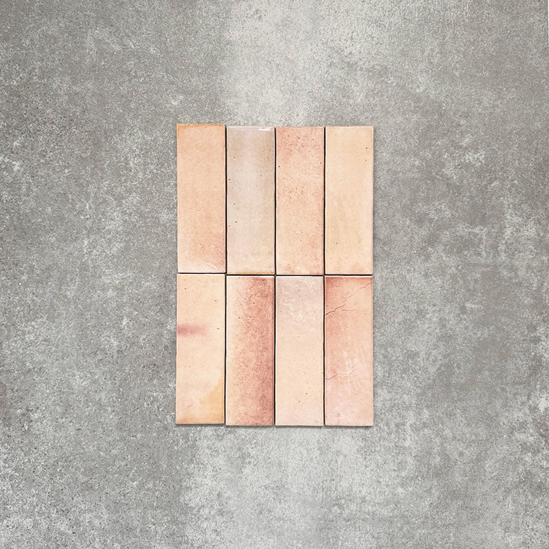 Close-up of Saigon Rose Pink Brick Wall tiles in a Moroccan-style design, 5.1 × 16.1cm glossy ceramic tiles with soft blush and rose colour variation, shown laid vertically.