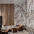 Living area featuring Viola Polished Marble effect 60 × 60cm porcelain wall and floor tiles, styled with warm wood panelling, leather seating, and soft furnishings, highlighting dramatic veining and a high-gloss finish.