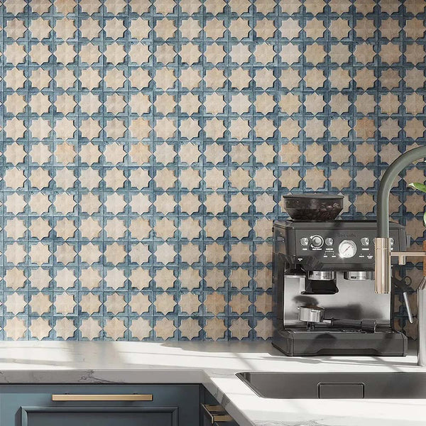 Kitchen featuring Zanzibar Moroccan Arena Blue wall tiles as a striking splashback, showcasing a blue and cream Moroccan style geometric pattern, paired with navy cabinetry, white worktops, brushed brass handles and contemporary stainless steel fixtures.