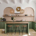 Kitchen featuring Zanzibar Moroccan Cotto White wall tiles in a warm terracotta and white Moroccan style geometric pattern, paired with sage green cabinetry, natural wood worktops, woven pendant lights and Mediterranean-inspired styling.