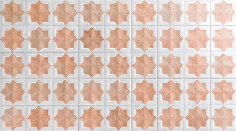 Close-up of Zanzibar Moroccan Cotto White ceramic wall tiles featuring a repeating Moroccan style star pattern in warm terracotta and soft white with a glossy finish, ideal for kitchen splashbacks, bathroom walls and decorative feature walls.