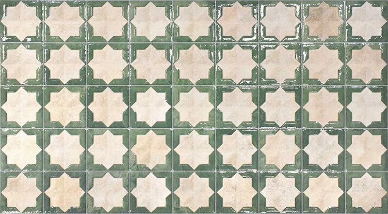 Close-up of Zanzibar Moroccan Emerald Green ceramic wall tiles featuring a repeating Moroccan style geometric star pattern in soft emerald green and warm ivory tones, with a glossy glazed finish and subtle distressed detailing for an authentic handcrafted look.