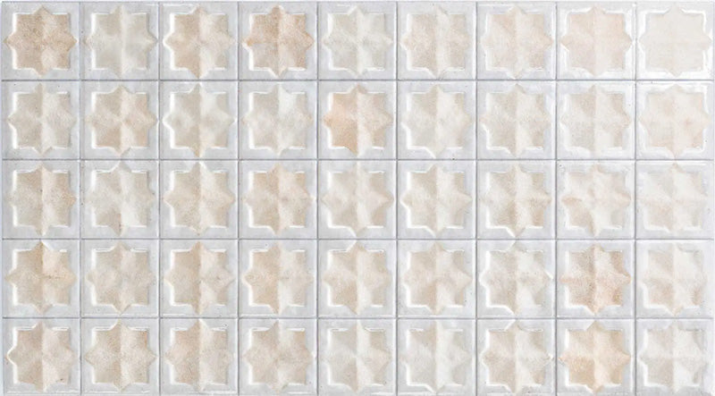 Close-up of Zanzibar Moroccan Natural White ceramic wall tiles featuring a repeating Moroccan style geometric star pattern in soft white and warm natural tones, with a glossy glazed finish, subtle shade variation and handcrafted-inspired detailing.